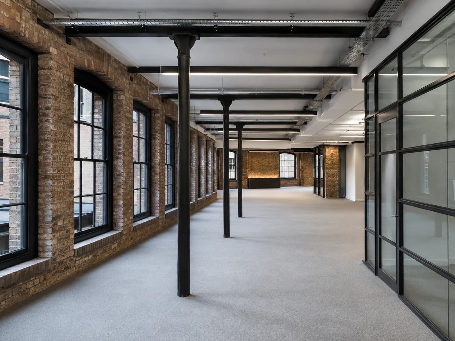The interior of a fitted-out commercial office suite in a converted British warehouse